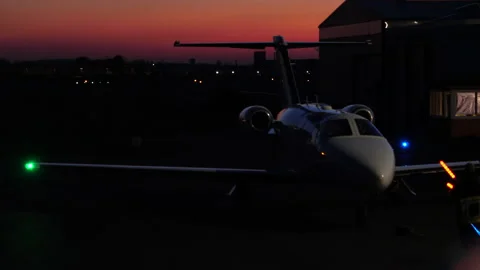 Small Private Jet Being Guided by Marshaller to Parking Spot. Night. Stock Footage 149995892