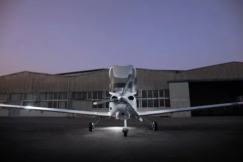 Small private jet with opened door in front of a hangar Stock Photos
