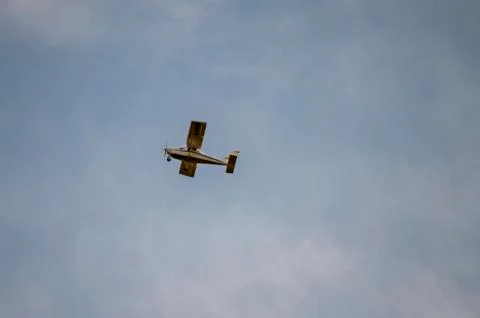 Small private plane flying in the clouds Foto stock