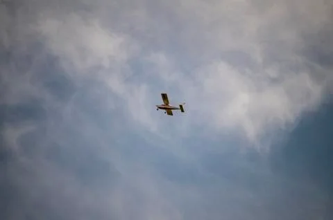 Small private plane flying in the clouds Stock Photos