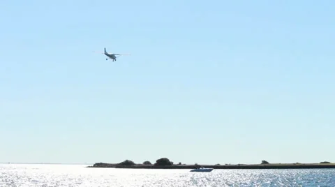 Small private plane landing over tropical setting Stock-Footage 34553847