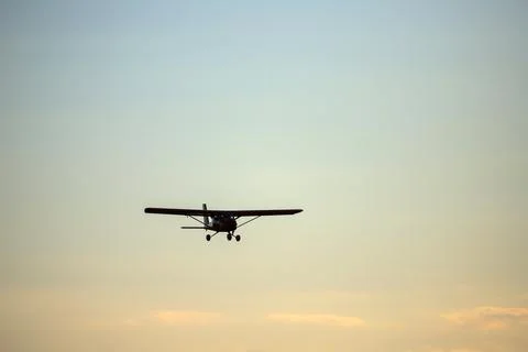 Small private propeller plane flies in the sky Stock Photos