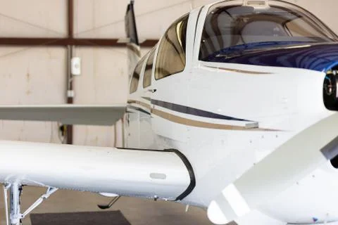 Small private propeller plane in hangar Stock Photos