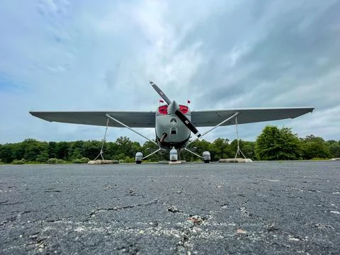 Small private single engine plane resting on tarmac. Stock Photos