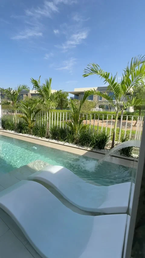 A small private swimming pool in the backyard of a luxury villa in Dubai on a Stock Footage 310734997