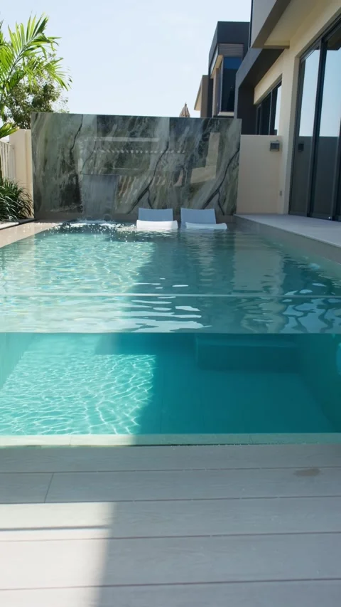 A small private swimming pool in the backyard of a luxury villa in Dubai on a Stock Footage 310736060