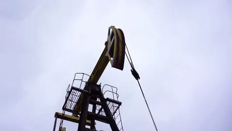 Small private yellow derrick pumps oil. Video stock 71702948