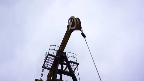Small private yellow derrick pumps oil. Stock-Footage 71703743