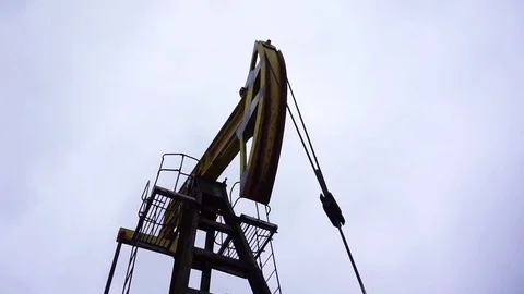 Small private yellow derrick pumps oil. Stock Footage 71704058