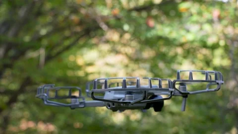 Small professional drone hovering close to the ground in nature Stock Footage 320891313