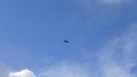 Small propeller airplane flying in blue sky Stock Footage 334191505