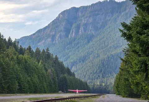Small Propeller Airplane on Remote Mountain Airstrip Stock Photos