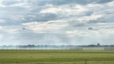 Small propeller airplanes flying in cloudy sky near airport perimeter fence Stock Footage 340394547