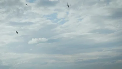 Small propeller airplanes flying in cloudy sky near airport perimeter fence Stock Footage 340394764