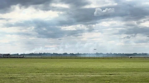 Small propeller airplanes flying in cloudy sky near airport perimeter fence Stock Footage 340394850