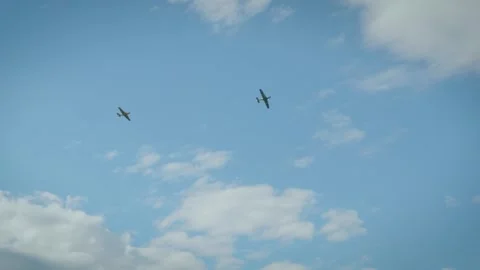 Small propeller airplanes flying in cloudy sky near airport perimeter fence Stock Footage 340395264