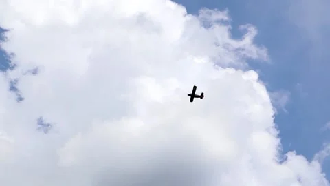 A small propeller-driven private plane flies in the sky with clouds. Stock Footage 155282161