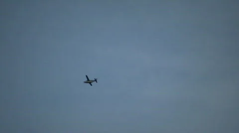 Small propeller plane flies by amidst blue sky (High Definition) Stock Footage 67983