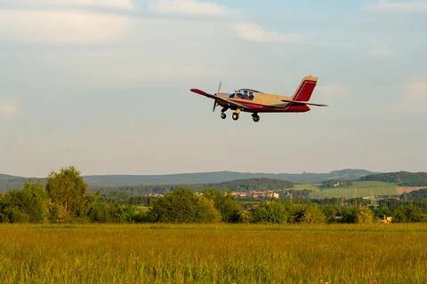 Small Propeller Plane Flying Over Field Stock-Fotos