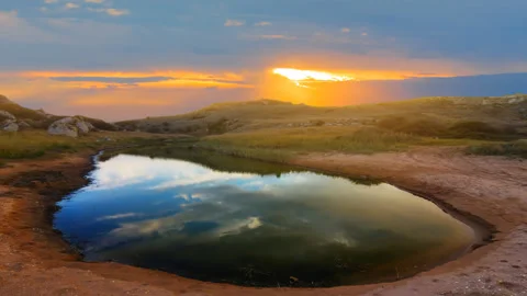 Small puddle among sandy prairie at the dramatic sunset Stock Footage 255119700