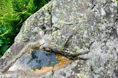 Small puddle in stones with sky reflection. Mountains of North Ossetia Stock Photos