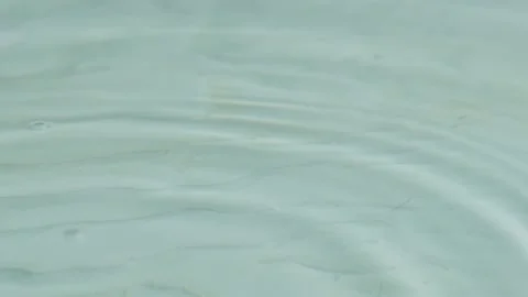 A small puddle of water with drops falling from the sky Video stock 274860000