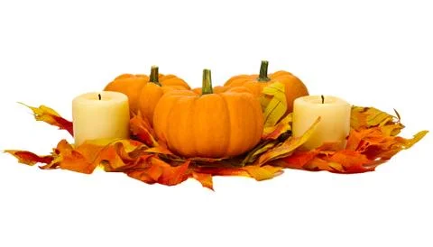 Small pumpkins and candles with fall leaves Foto stock