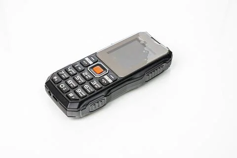 Small push-button cell phone on a white background. Obsolete model. Space f.. Stock Photos