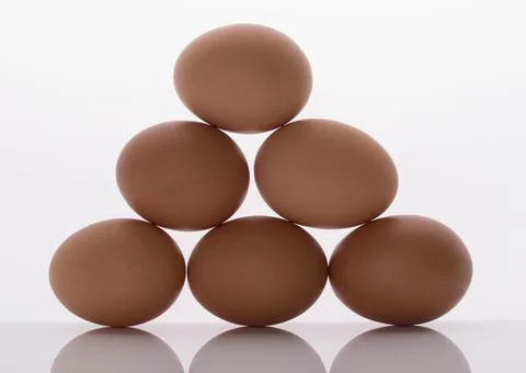 Small pyramid made from six large eggs Stock Photos