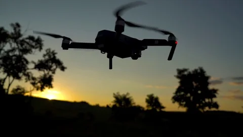 Small quadrocopter flying against the sky. Slow motion Stock Footage 77907731