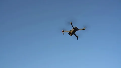 Small quadrocopter flying against the sky Stock Footage 77907741