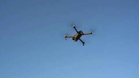 Small quadrocopter flying against the sky. Slow motion Stock Footage 78420103