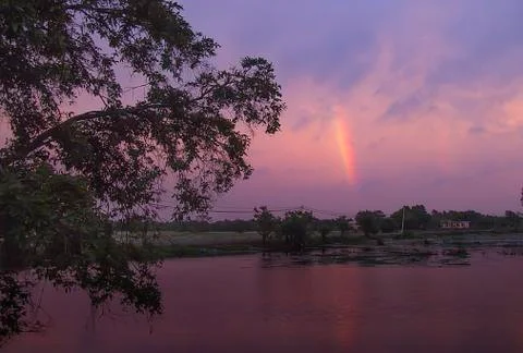 Small rainbow in the evening sky Stock Photos