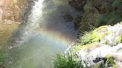 Small rainbow next to a river Stock Footage 47993026