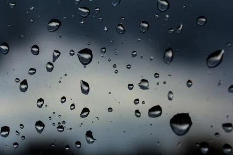 A small raindrop rests on the glass after rain. Foto stock