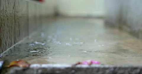 Small raindrops falling and splashing on a puddle of stagnant water. Stock Footage 316487091