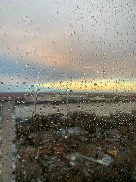 Small raindrops run down the window glass Stock Photos