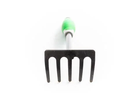 Small rake gardening 5 teeth with green handle Stock Photos