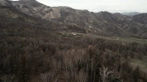 A small ranch located in the high-altitude mountains. Spring landscape. Aerial Stock Footage 197403584