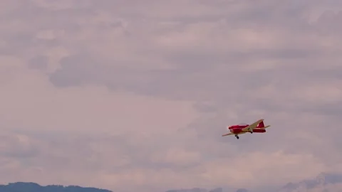 Small RC propeller aircraft model flying against the cloudy sky Stock Footage 225531749
