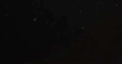 Small real dust particles floats over black backgound Stock Footage 63759553