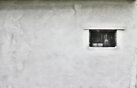 Small rectangular window on a white ruined wall Stock Photos