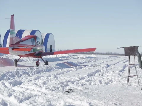 Small red airplane prepares for take-off. Snow winter. Stock Footage 72401272