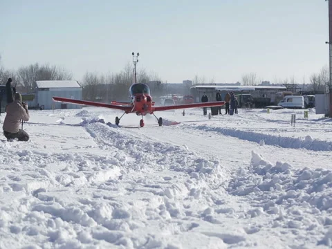 Small red airplane prepares for take-off. Snow winter. Stock Footage 72408721