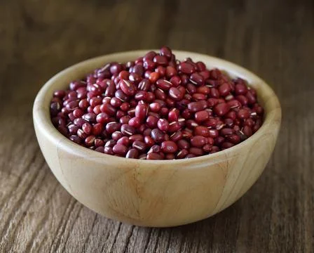 Small red bean or azuki in wood bowl on table Stock Photos