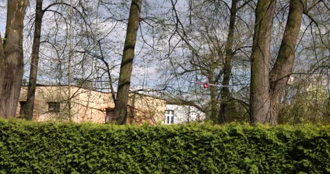 Small red blue styrofoam airplane coming out flying and landing on the grass Stock Footage 240133892