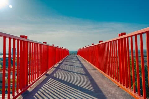Small red bridge close up. Red fences. Metal bridge over the highway. Stock Photos