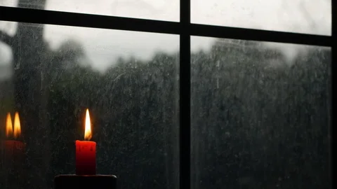 Small Red Candle in Front of Big Window Pane on Gloomy Day Stock Footage 101400888