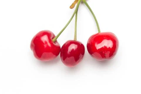 Small red cherries on a white background Stock Photos