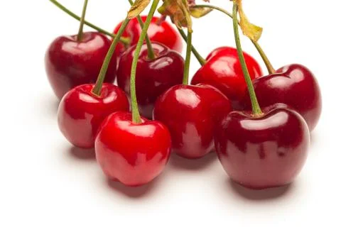 Small red cherries on a white background Stock Photos